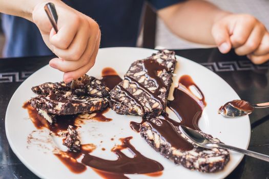 Chocolate patty cake with chocolate sauce on a white plate