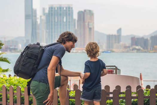 Father and son are walking around Hong Kong. Traveling with children concept.