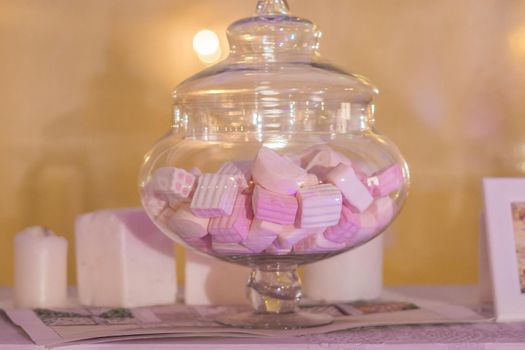 White and pink marshmallows in a jar.