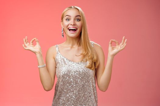 Excited carefree happy stress-free charming blond european woman calm feelings under control show zen gesture standing nirvana lotus pose meditating joyfully smiling, calmd-down red background.