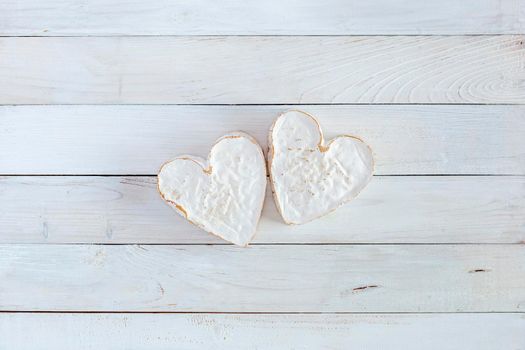 two heart shape cheese on the white wooden background, concept of Valentine Day, top view, copy space