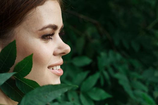 portrait of a woman Cosmetology nature green leaves glamor close-up. High quality photo