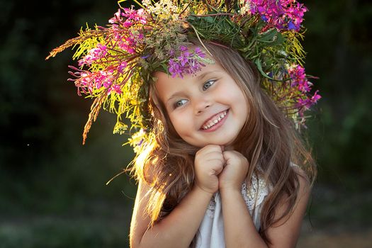 beautiful little girl in a wreath. High quality photo