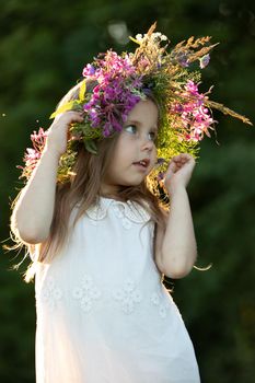 beautiful little girl in a wreath. High quality photo