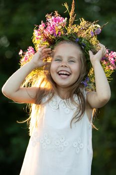 beautiful little girl in a wreath. High quality photo