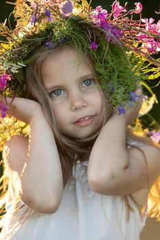 beautiful little girl in a wreath. High quality photo