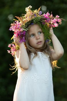 beautiful little girl in a wreath. High quality photo