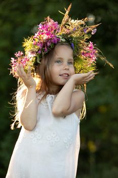 beautiful little girl in a wreath. High quality photo