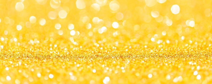 sparkles of yellow glitter abstract background. Copy space. Banner