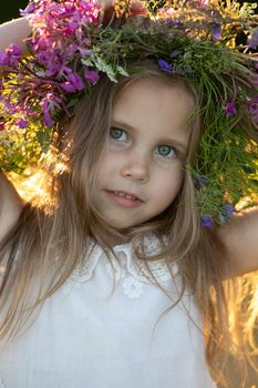 beautiful little girl in a wreath. High quality photo