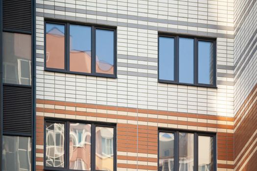 laminated plastic windows on the facade of apartment buildings.