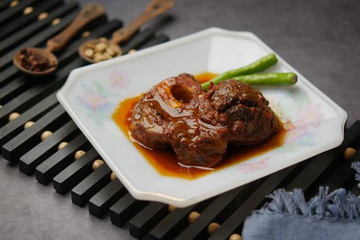 traditional Indian curry lamb masala in a bowl on table.