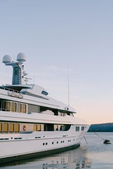 Luxurious double-deck yacht moored at the pier in Porto. Montenegro. High quality photo