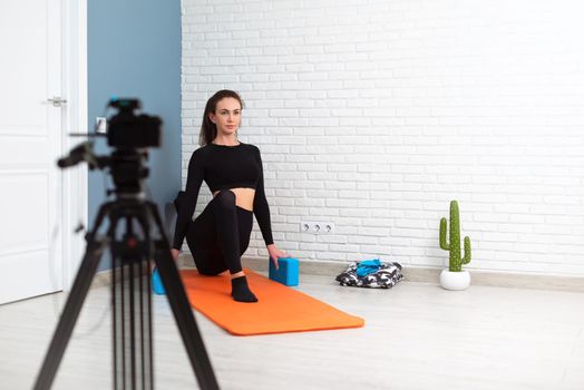 girl shoots a stretching and twine workout on camera