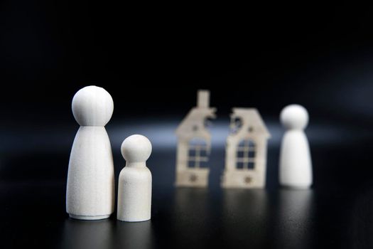Divorce, division of property, poverty and no money concept. Wooden broken house on black background. Mortgage, rent, realtor concept copy space space for text