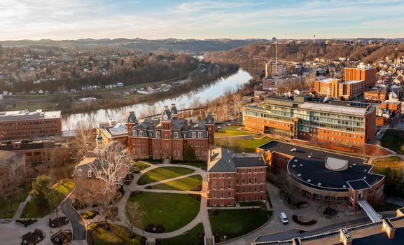 Aerial drone panoramic shot of the downtown campus of WVU in Morgantown West Virginia showing the river in the distance