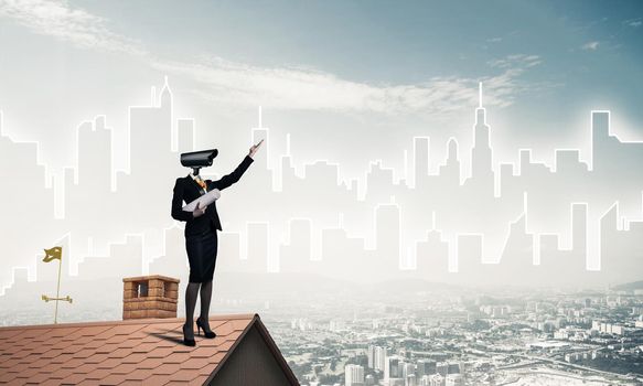 Faceless businesswoman with camera zoom instead of head standing on house roof