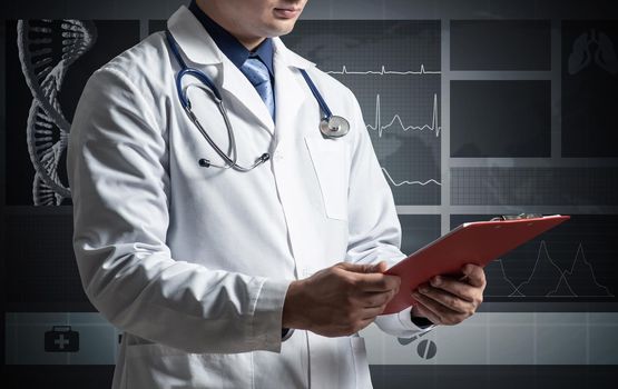 Doctor holds a tablet with documents. Photo without face