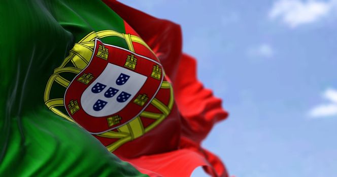 Detail of the national flag of Portugal waving in the wind on a clear day. Democracy and politics. European country. Selective focus