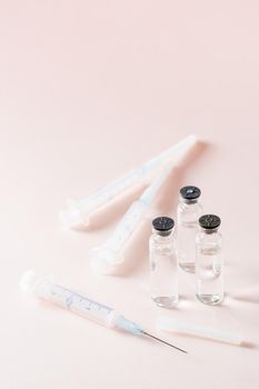 Vaccination and Immunization. Vaccine vials and clean syringes. Vertical view