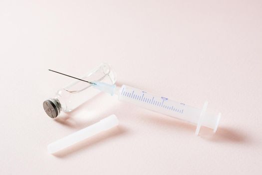 Vaccination and Immunization. Opened syringe on a glass vial with vaccine