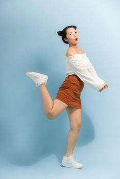 Full body photo of cheerful excited energetic girl jump enjoy spring free time holiday weekend isolated over bright color background