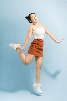 Full length profile photo of cute funny lady good mood pretty legs toothy smiling wear summer dress on blue background