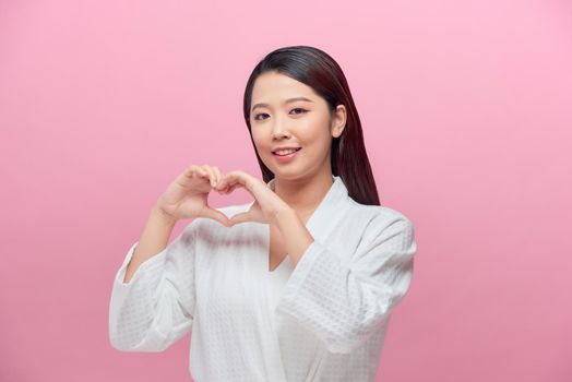 Portrait of young beautiful asian woman hands gesture in heart shape