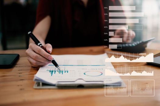 Close-up of a businesswoman using a calculator to audit the company's budget. Tax information is calculated by accountants.