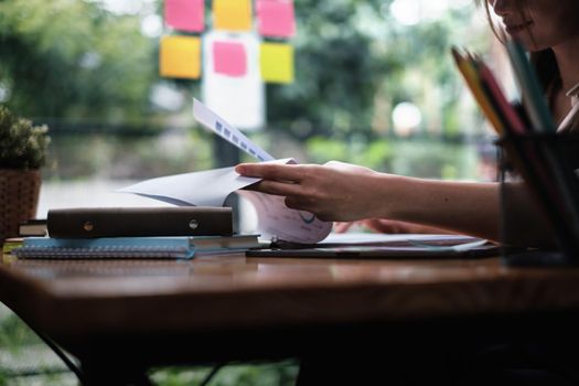 A businesswoman examines a financial chart in order to make arrangements. Investment concept for a business fund