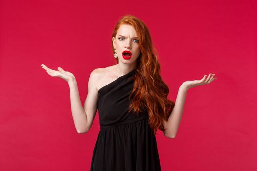 Fashion, luxury and beauty concept. Portrait of arrogant and frustrated young pretty redhead woman complaining on restaurant waiters, shrugging with hands spread sideways dismay, look annoyed.