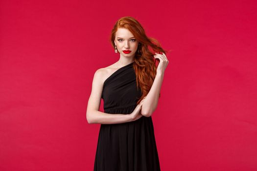 Elegance, fashion and woman concept. Seductive gorgeous redhead woman in black fashionable dress, attend formal event, party or prom, look assertive and determined, know what she wants.