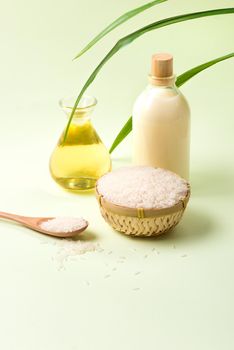 Rice bran oil in a glass and jar with uncooked jasmine rice 