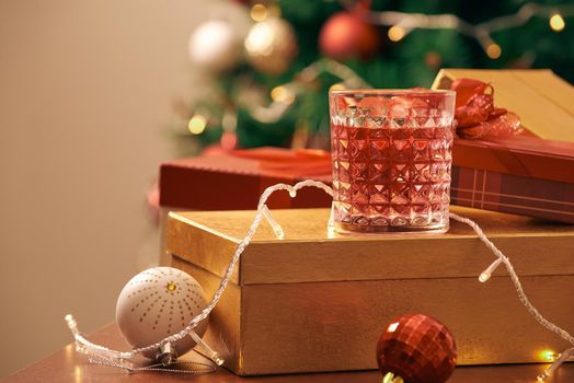 Decorated christmas tree with colorful balls and gift boxes at home 