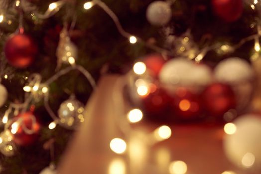 Decorated Christmas tree on blurred, sparkling and fairy background