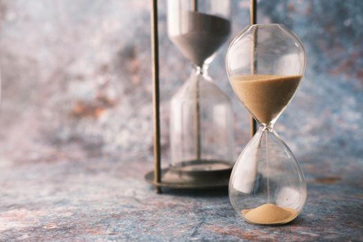 hourglass on table, Sand flowing through the bulb of Sandglass.