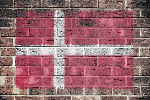 A Denmark flag painted on brick wall background