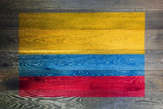 A Colombia flag on rustic old wood surface background