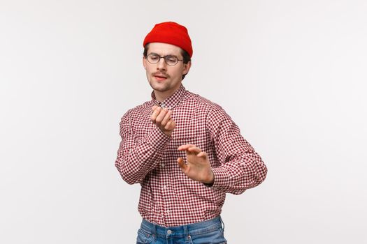 Geeky guy vibing and having fun. Carefree cute funny man in red beanie and glasses, dancing clumsy on dancefloor, enjoy awesome office party, celebrating holiday or triumphing over win.