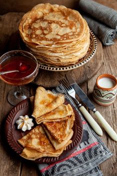 Pancake foods. A stack of thin pancakes on a plate. Russian pancake week.Shrove tide. Thin pancake with crispy crust. Homemade pastries. Pancakes for breakfast. Appetizing food.