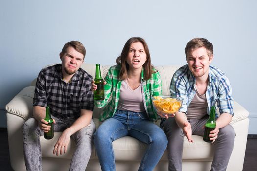 Happy friends or football fans watching soccer on tv and celebrating victory at home.Friendship, sports and entertainment concept.