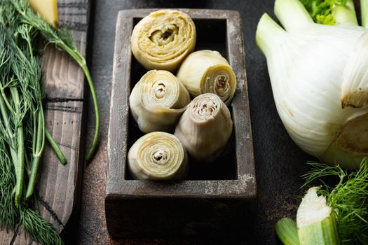 Canned artichokes with olive oil, on old rustic background