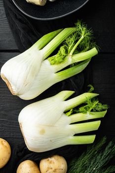 Fresh florence fennel bulb, on black wooden table, top view