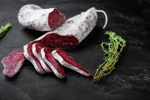 Longaniza, traditional salami spanish sausage on black background.