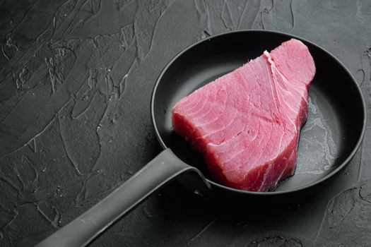 Raw organic tuna fillet. Seafood set, on black stone background , with copyspace and space for text