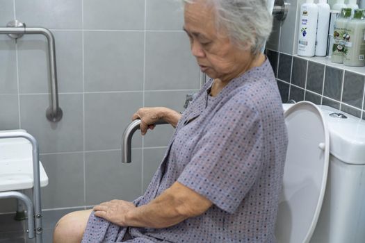 Asian senior or elderly old lady woman patient use toilet bathroom handle security in nursing hospital ward, healthy strong medical concept.