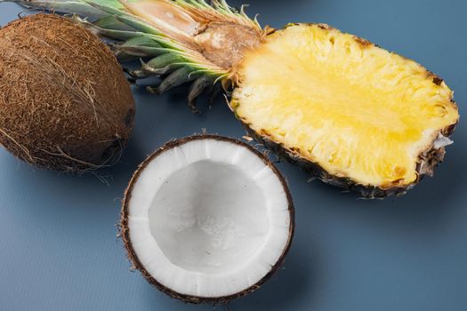Fresh fruits, pineapple and Coconut set, on blue textured summer background, top view flat lay