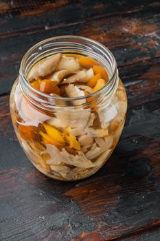 Pickled mushrooms set, on old dark wooden table background