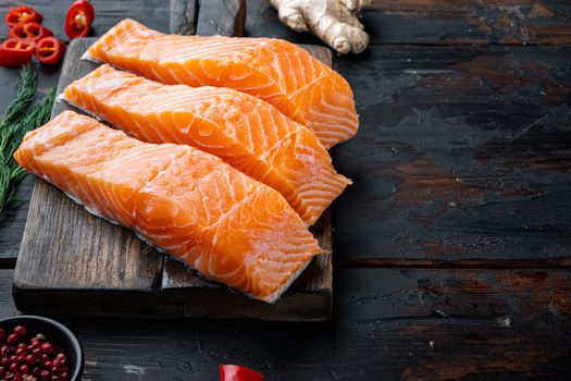 Raw salmon meat for cutlets, on old wooden table with space for text