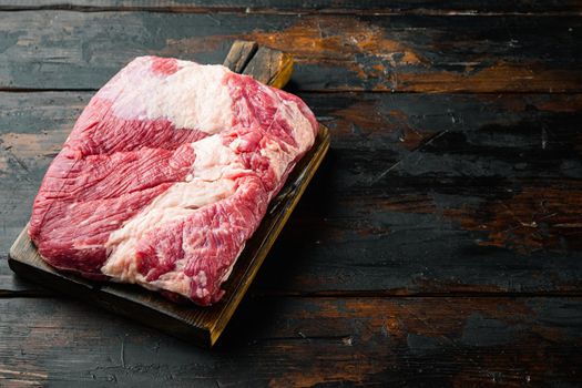 Snack cross cut, raw beef brisket meat set, on old dark wooden table background, with copy space for text